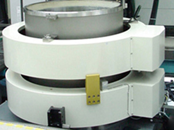 Large cylindrical solenoid magnet unit mounted on an assembly stand