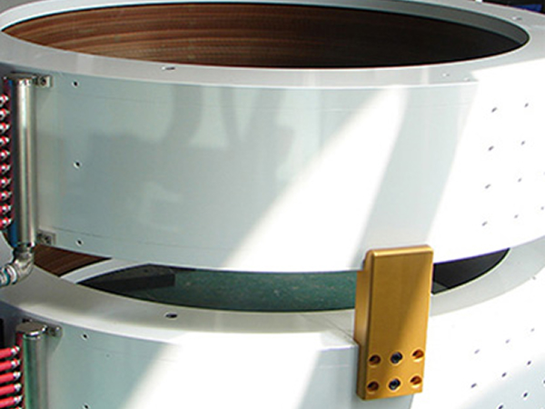 Close-up view of the inner copper coil winding and white ring casing of a solenoid magnet