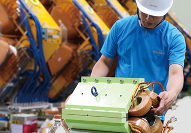 Technician assembling magnet components in a manufacturing facility